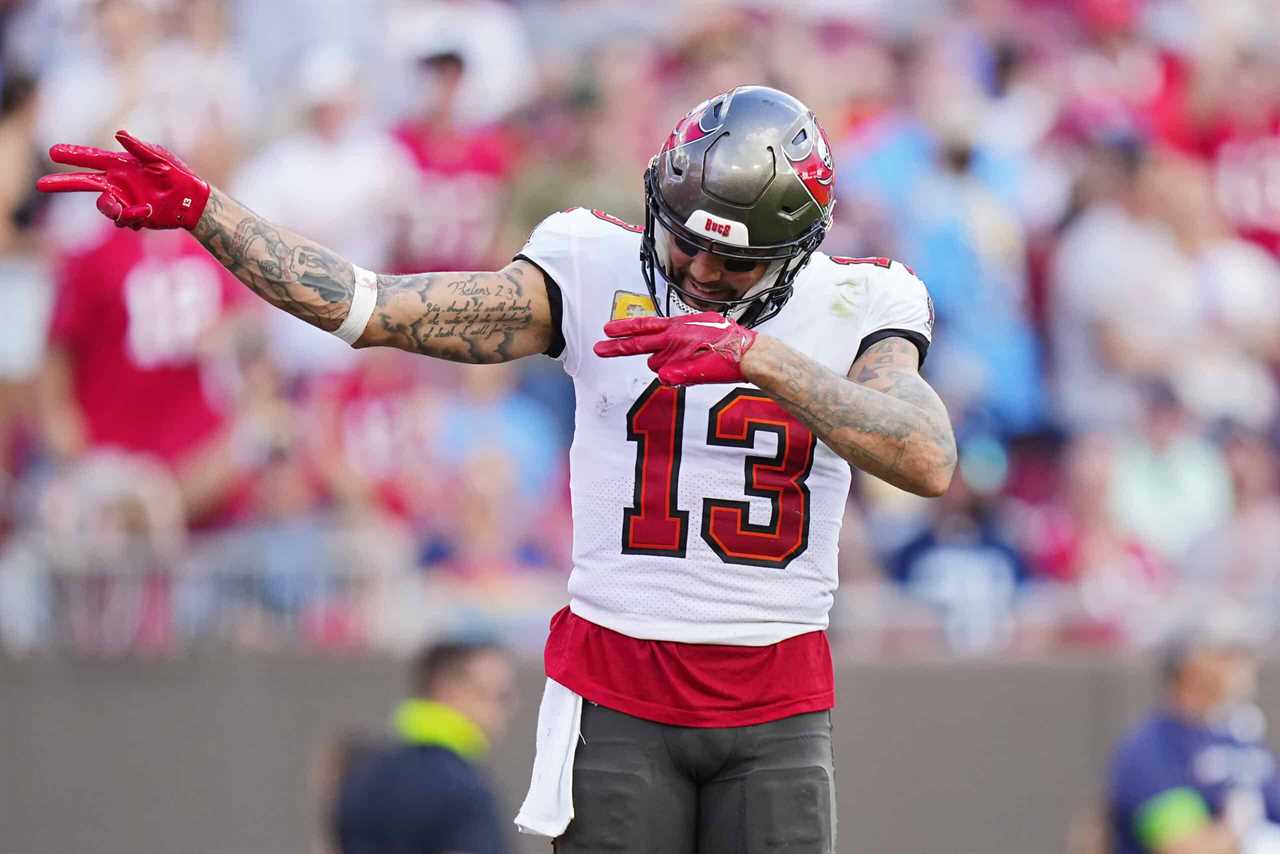 Mike Evans #13 of the Tampa Bay Buccaneers reacts after his receiving touchdown during the third quarter against the Tennessee Titans at Raymond James Stadium on November 12, 2023 in Tampa, Florida.