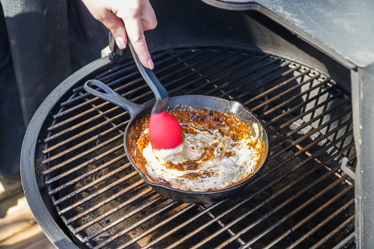 starting to stir cream cheese and chil mixture with rubber spatula