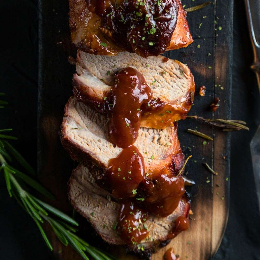sliced-pork-tenderloin-on-wooden-cutting-board