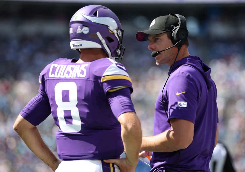 Kirk Cousins #8 of the Minnesota Vikings talks with head coach Kevin O'Connell during the first half against the Carolina Panthers at Bank of America Stadium on October 01, 2023 in Charlotte, North Carolina. 
