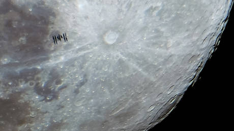 The International Space Station (ISS) is photographed with the full moon in the background from Konya, Turkiye on January 24, 2024.