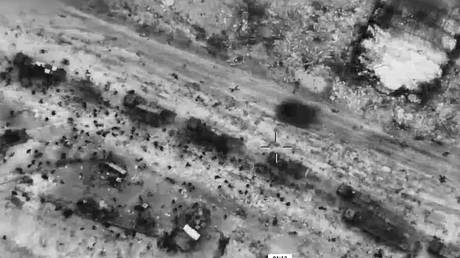 A screen grab captured from a video shows Israeli forces targeting Palestinians, surrounding humanitarian aid trucks in Gaza City, February 29, 2024