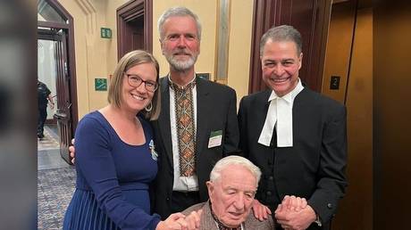 Canadian House Leader Karina Gould and former Speaker Anthony Rota hold hands with Nazi Waffen-SS veteran Yaroslav Hunka in a now deleted social media photo