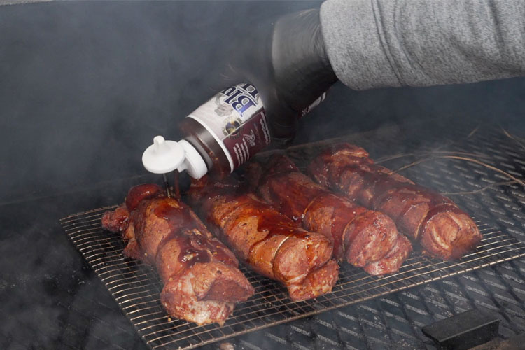 squirting glaze onto pork tenderloins