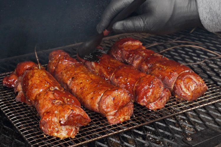 pork tenderloins being brushed with glaze