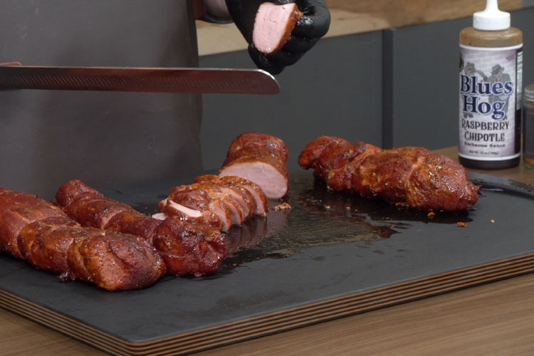 pork tenderloin being sliced 