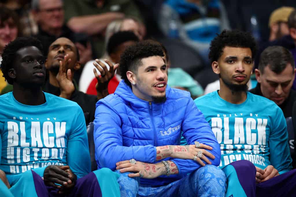 LaMelo Ball #1 of the Charlotte Hornets looks on from the sideline during the second half of the game against the Toronto Raptors at Spectrum Center on February 07, 2024 in Charlotte, North Carolina. 