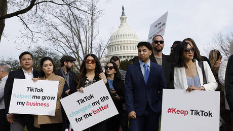 Demonstrators hold signs in support of TikTok outside the US Capitol in Washington, DC, March 13, 2024.