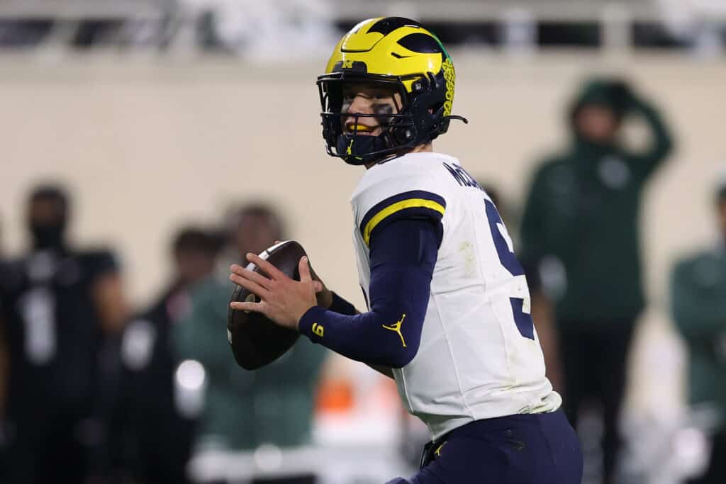 EAST LANSING, MICHIGAN - OCTOBER 21: J.J. McCarthy #9 of the Michigan Wolverines throws a first half pass against the Michigan State Spartans at Spartan Stadium on October 21, 2023 in East Lansing, Michigan.