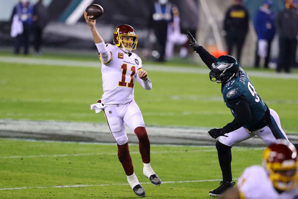 Quarterback Alex Smith #11 of the Washington Football Team throws an incomplete pass as he is pressured by defensive tackle Malik Jackson #97 of the Philadelphia Eagles during the first quarter of the game at Lincoln Financial Field on January 03, 2021 in Philadelphia, Pennsylvania.