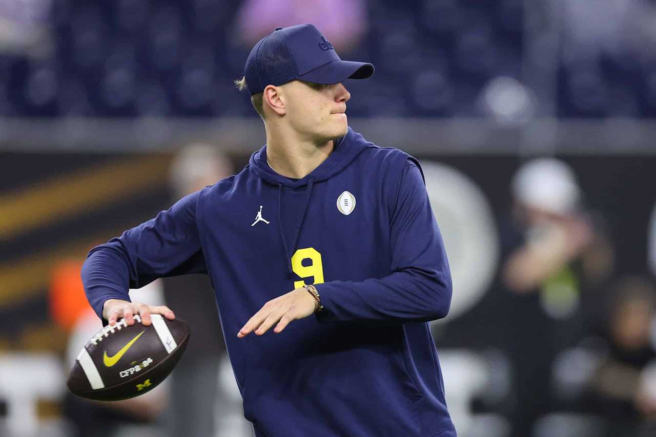HOUSTON, TEXAS - JANUARY 08: J.J. McCarthy #9 of the Michigan Wolverines participates in warmups prior to the 2024 CFP National Championship game against the Washington Huskies at NRG Stadium on January 08, 2024 in Houston, Texas. Michigan defeated Washington 34-13.