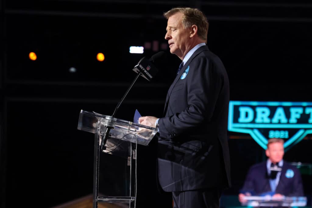 NFL Commissioner Roger Goodell announces Justin Fields onstage after being selected 11th by the Chicago Bears during round one of the 2021 NFL Draft at the Great Lakes Science Center on April 29, 2021 in Cleveland, Ohio.