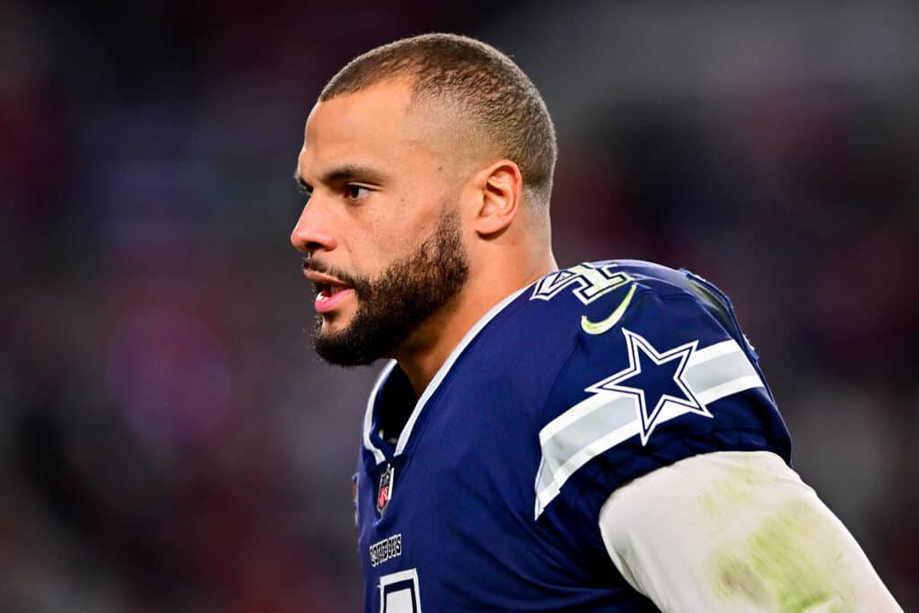 Dak Prescott #4 of the Dallas Cowboys runs off the field at halftime against the Tampa Bay Buccaneers in the NFC Wild Card playoff game at Raymond James Stadium on January 16, 2023 in Tampa, Florida.