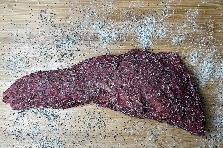 seasoned tri-tip on a wooden board