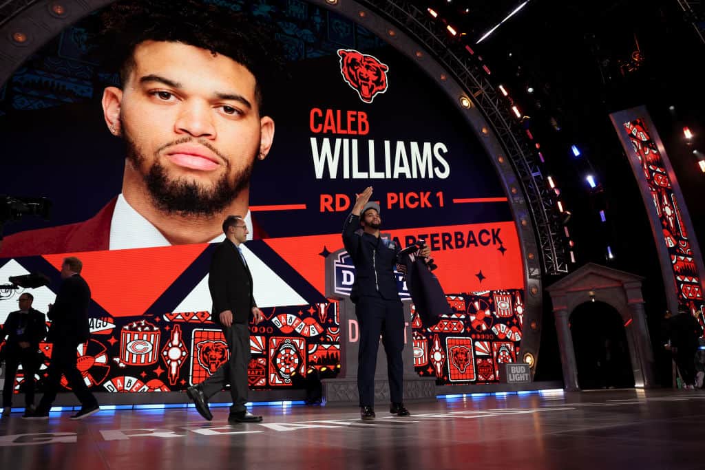Caleb Williams celebrates after being selected first overall by the Chicago Bears during the first round of the 2024 NFL Draft at Campus Martius Park and Hart Plaza on April 25, 2024 in Detroit, Michigan.