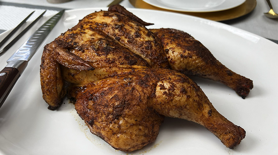 whole smoked pellet grill chicken on plate