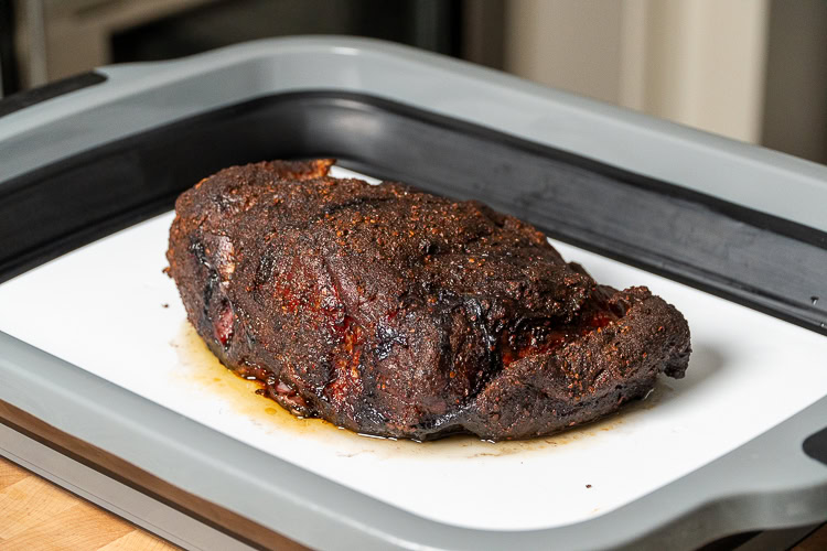 a piece of cooked pork butt resting on a white board