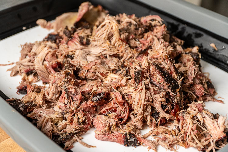 shredded no wrap pork butt on a white board