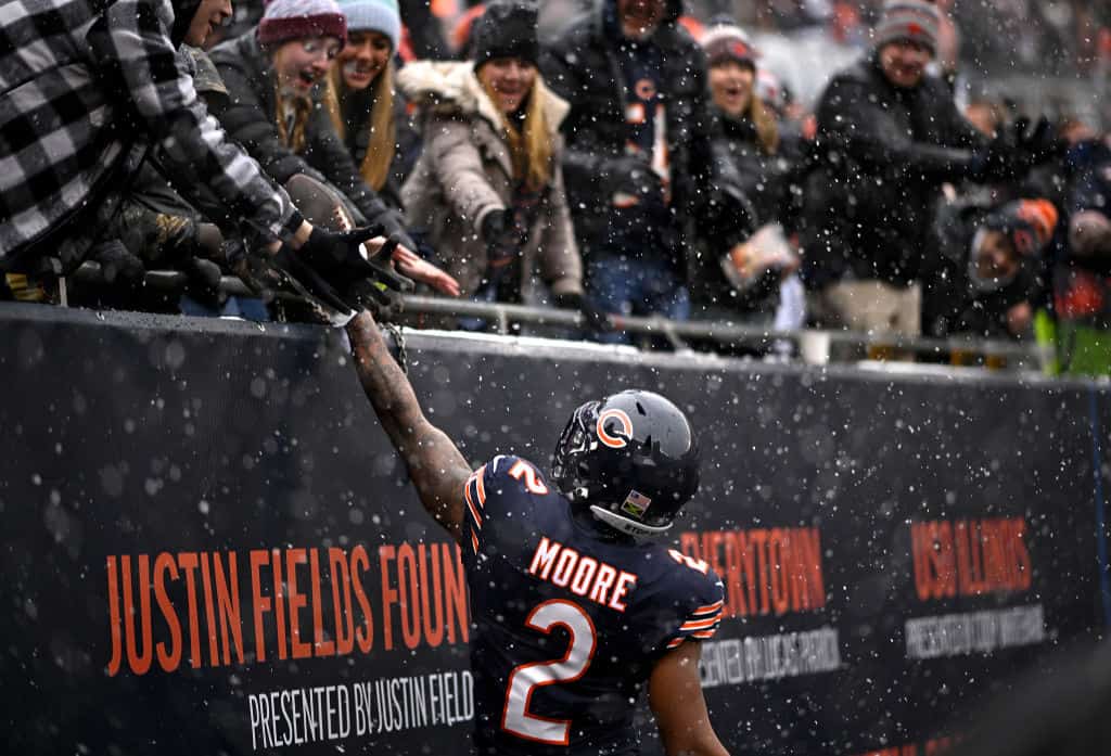 DJ Moore #2 of the Chicago Bears gives a fan a football after his receiving touchdown during the first quarter against the Atlanta Falcons at Soldier Field on December 31, 2023 in Chicago, Illinois.