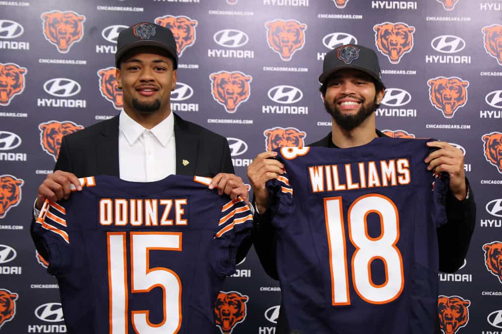 Rome Odunze #15 and Caleb Williams #18 of the Chicago Bears pose for a photo during their introductory press conference at Halas Hall on April 26, 2024 in Lake Forest, Illinois. Caleb Williams was selected first overall and Rome Odunze was selected ninth overall in the first round of the 2024 NFL Draft Thursday.