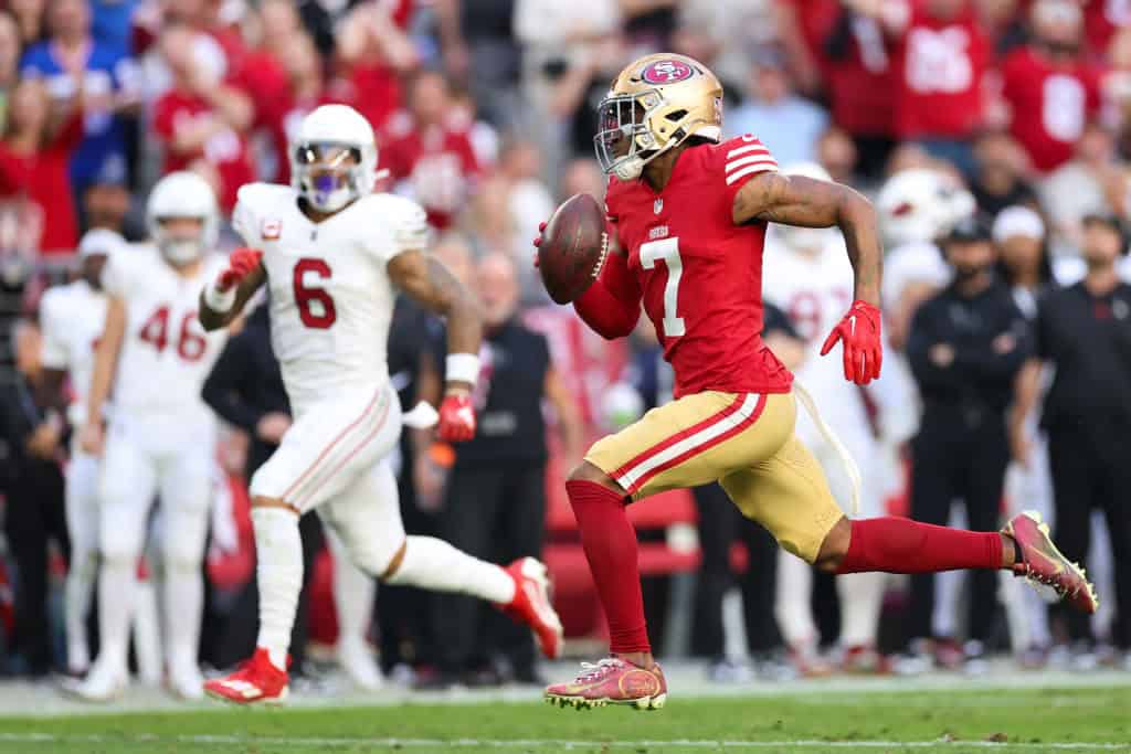 Charvarius Ward #7 of the San Francisco 49ers runs back a interception 66-yards for a touchdown during the first quarter against the Arizona Cardinals at State Farm Stadium on December 17, 2023 in Glendale, Arizona.