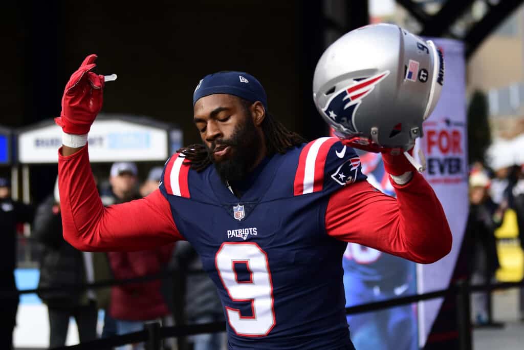 Matthew Judon #9 of the New England Patriots runs onto the field before a game against the Tennessee Titans at Gillette Stadium on November 28, 2021 in Foxborough, Massachusetts.