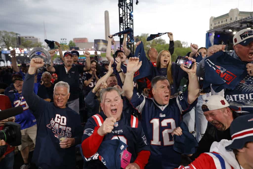 New England Patriots fans react to their teams selection in the second round of the 2023 NFL Draft at Union Station on April 28, 2023 in Kansas City, Missouri.