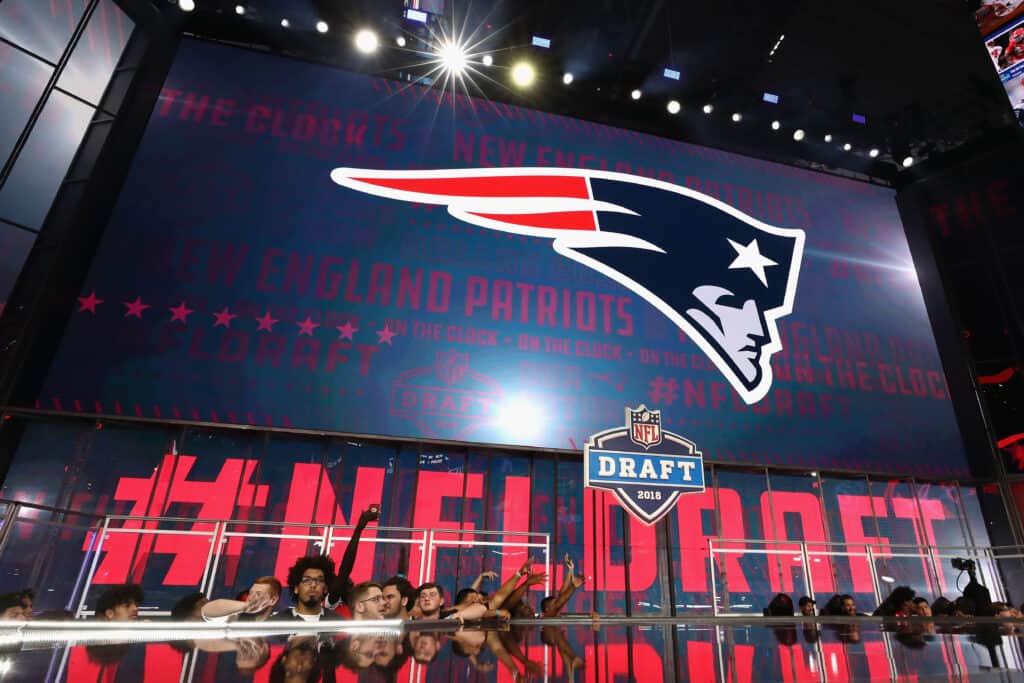 ARLINGTON, TX - APRIL 26: The New England Patriots logo is seen on a video board during the first round of the 2018 NFL Draft at AT&T Stadium on April 26, 2018 in Arlington, Texas.