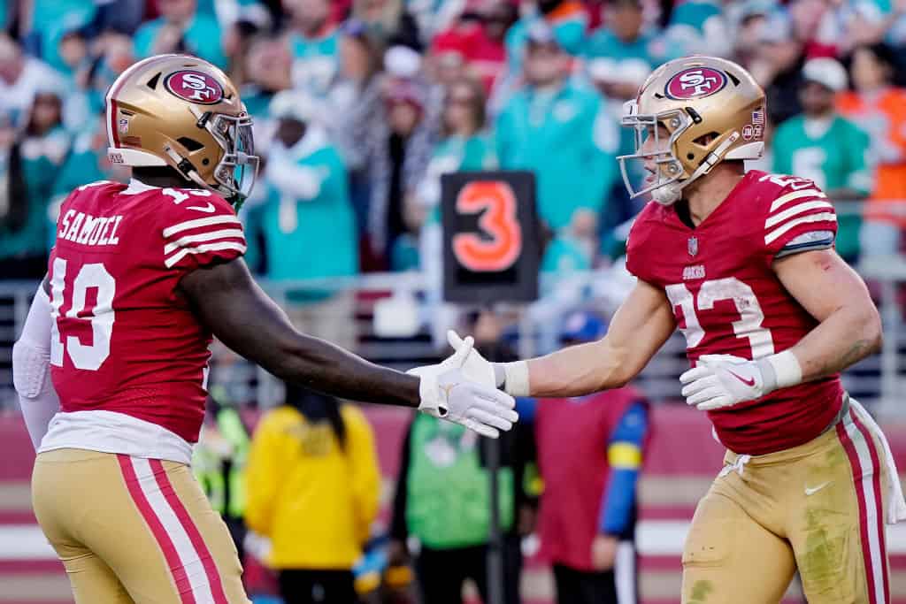 Deebo Samuel #19 of the San Francisco 49ers celebrates with Christian McCaffrey #23 of the San Francisco 49ers after McCaffrey's touchdown during the second quarter at Levi's Stadium on December 04, 2022 in Santa Clara, California. 