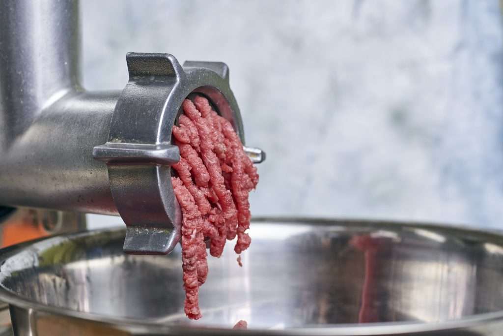 Meat grinder with meat