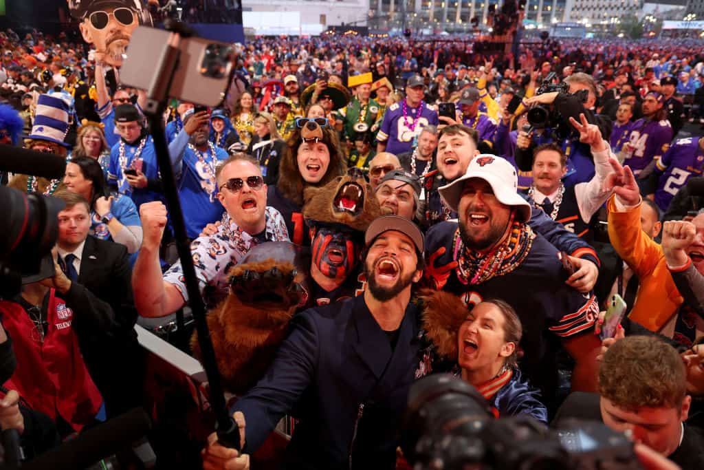 Caleb Williams celebrates with fans after being selected first overall by the Chicago Bears during the first round of the 2024 NFL Draft at Campus Martius Park and Hart Plaza on April 25, 2024 in Detroit, Michigan.