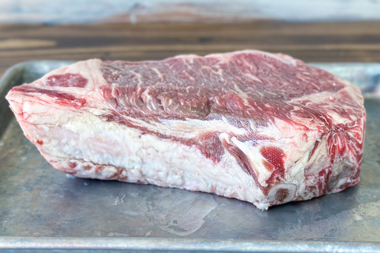 side on view of a raw delmonico steak