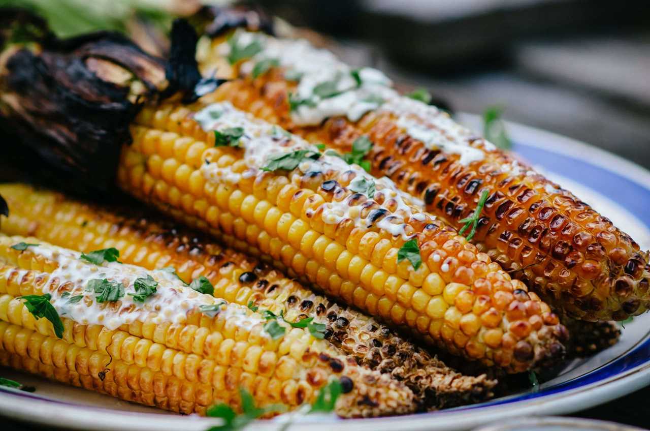 Smoked Corn on the Cob plated with toppings