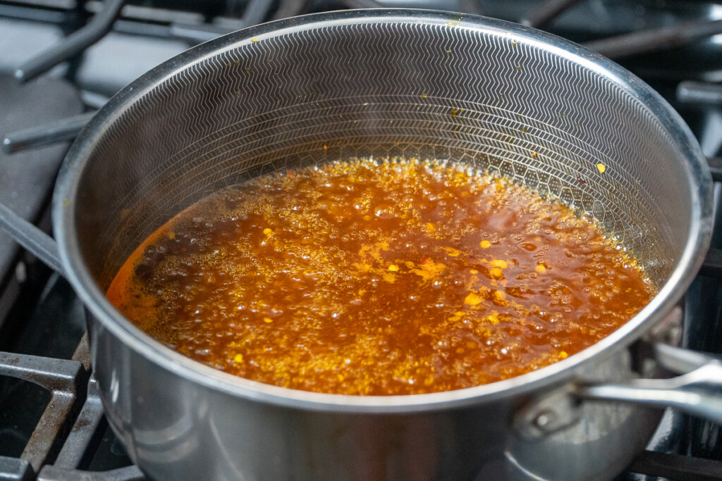 a pot of simmering cowboy candy liquid