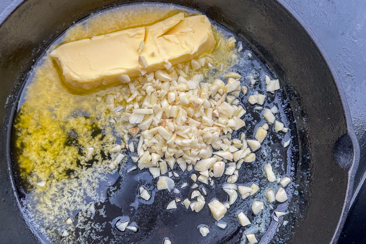 melting butter and chopped garlic in a cast pan