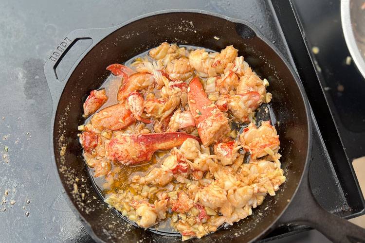 chopped lobster in a cast iron pan