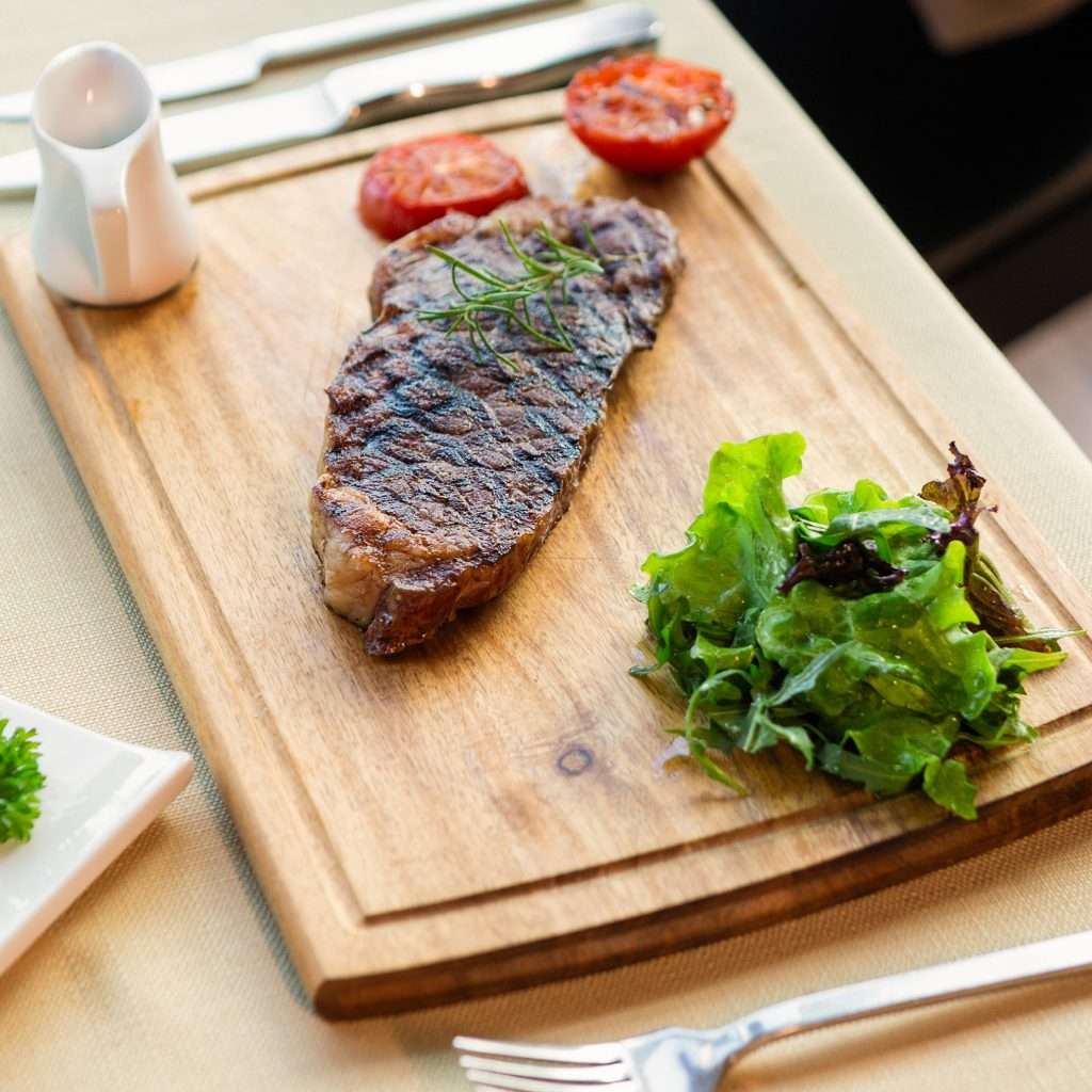 Steak temperature guide - Resting a steak on a wooden cutting board