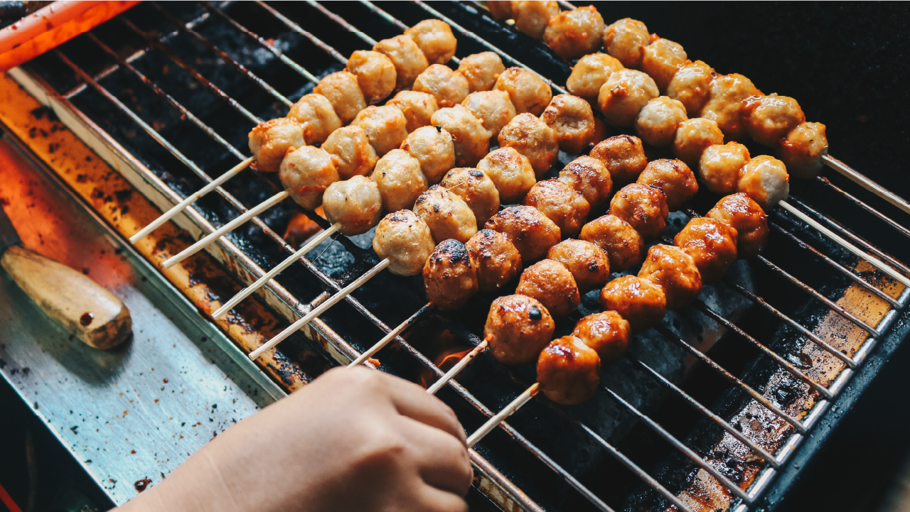 Smoking Skewered Meatballs on a grill