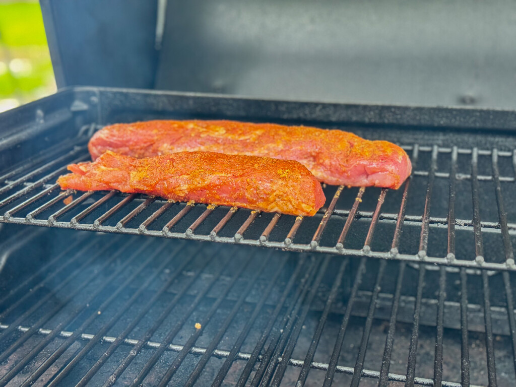 raw seasoned pork loins on the grill