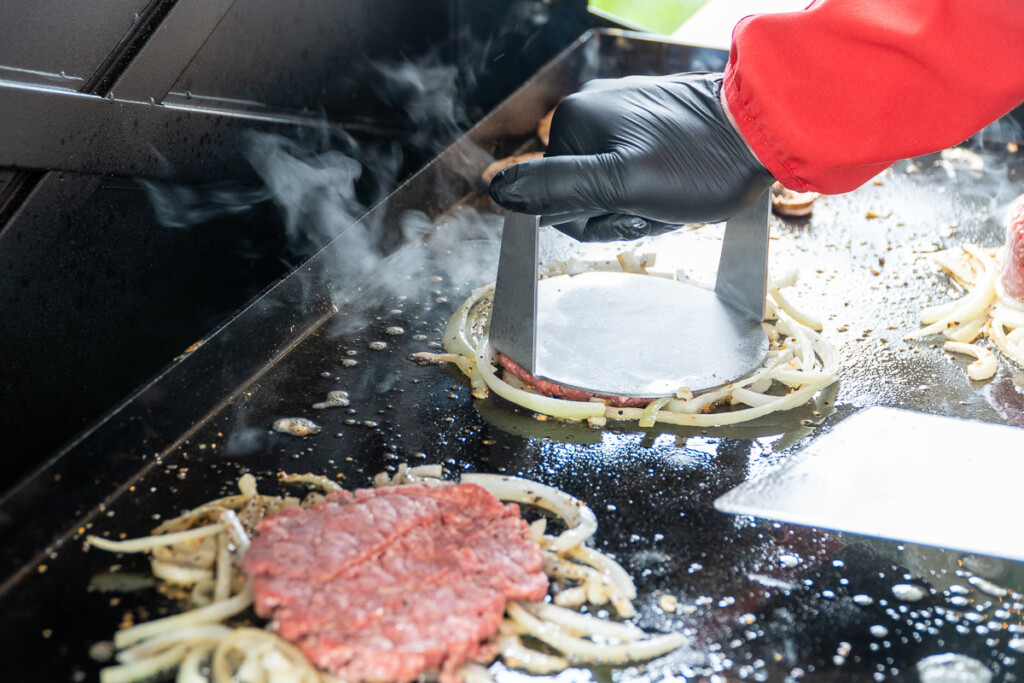 cooking smash burgers on Camp Chef GRIDIRON griddle