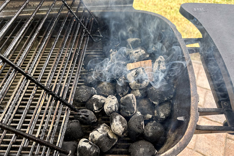 grill with lit charcoal banked up to one side