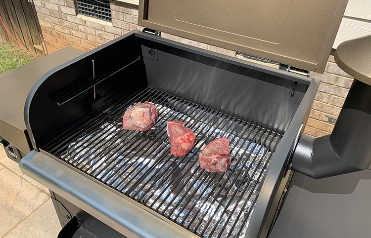 Grill drip plate covered with aluminum foil