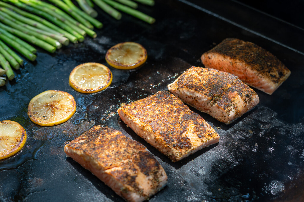 salmon fillets cooking on the griddle