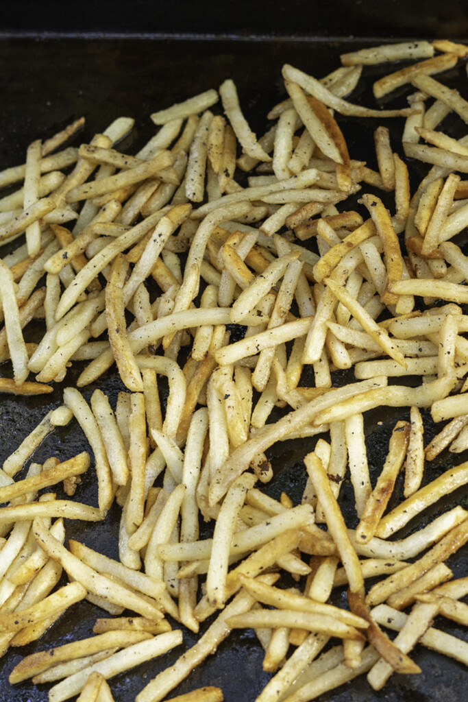 cooked French fries on the griddle