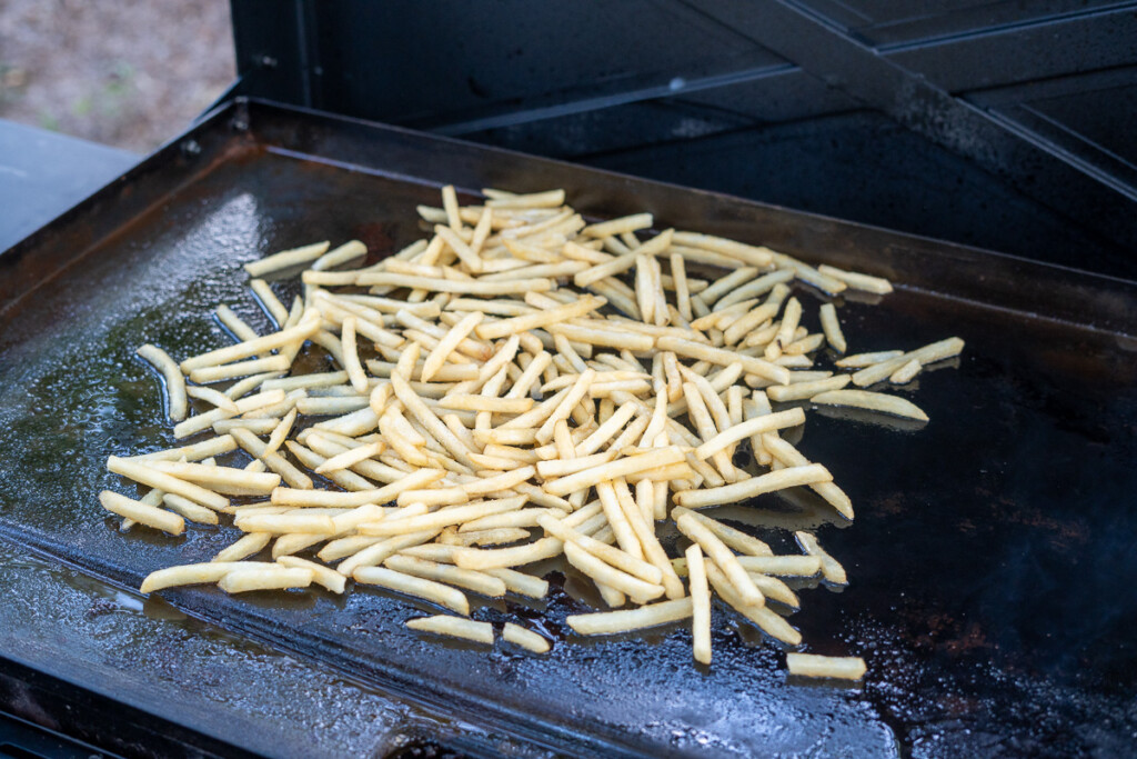 uncooked french fries on the griddle