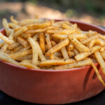 cooked french fries in a brown bowl