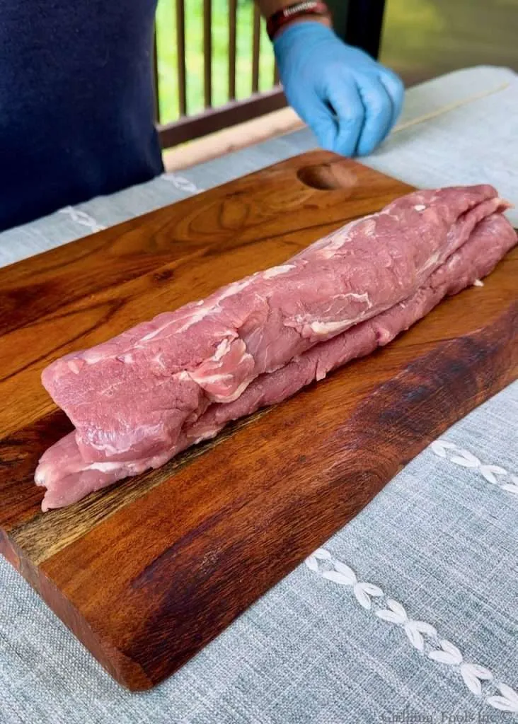 Stacked Pork Tenderloins on a Cutting Board