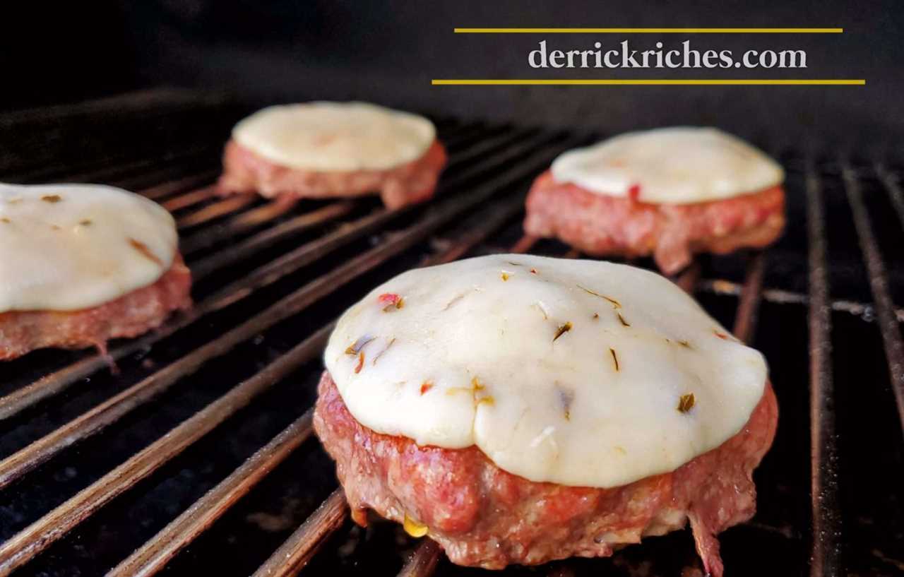 poultry patties on grill grates with pepper jack cheese on top