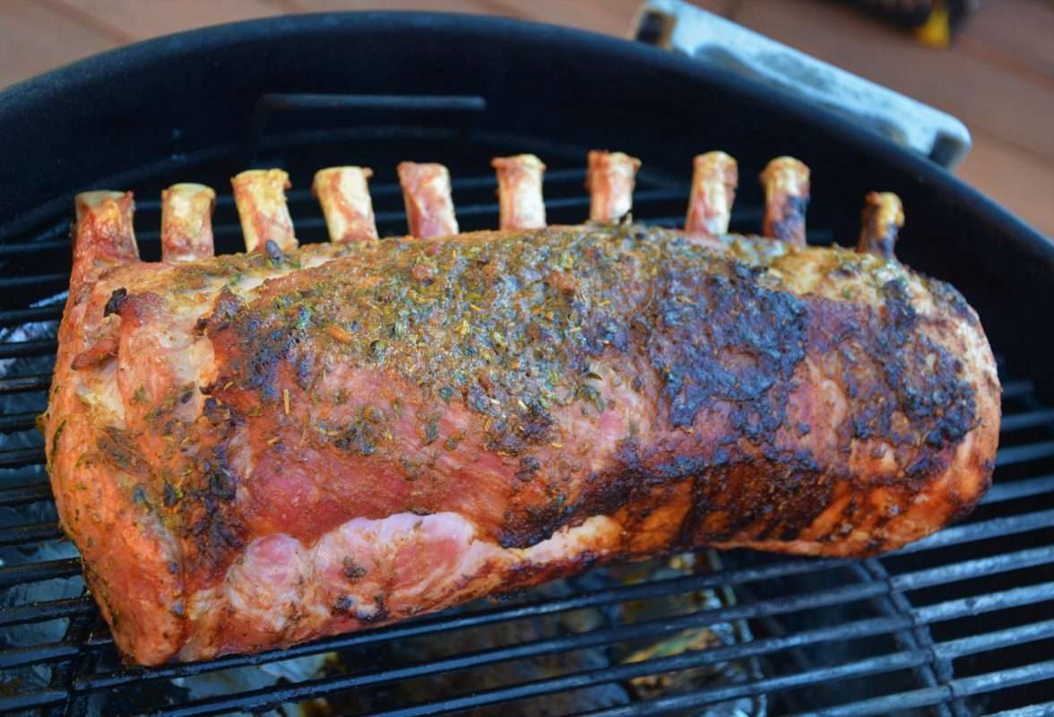 smoked rack of pork on charcoal grill