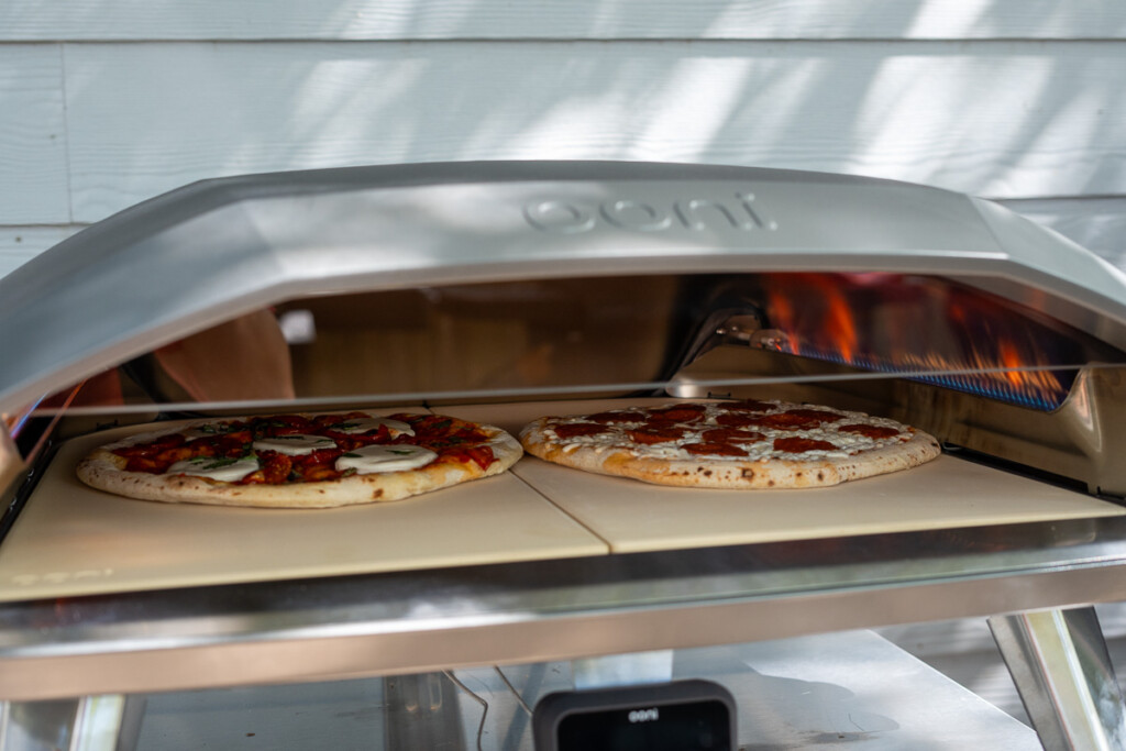 two pizzas cooking side by side in Ooni Koda 2 Max pizza oven